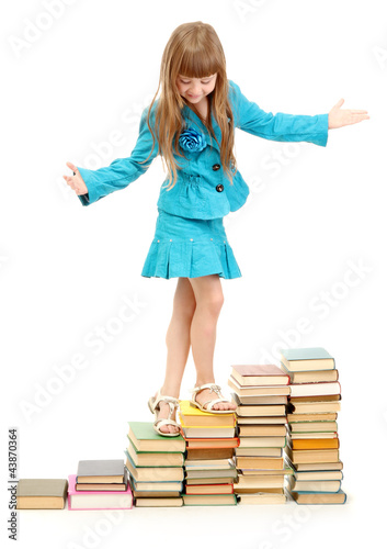 little girl with a books is...