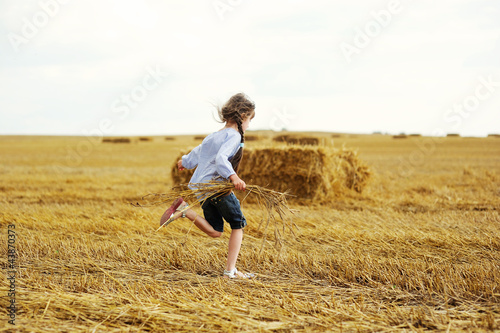 Little girl running around on a field