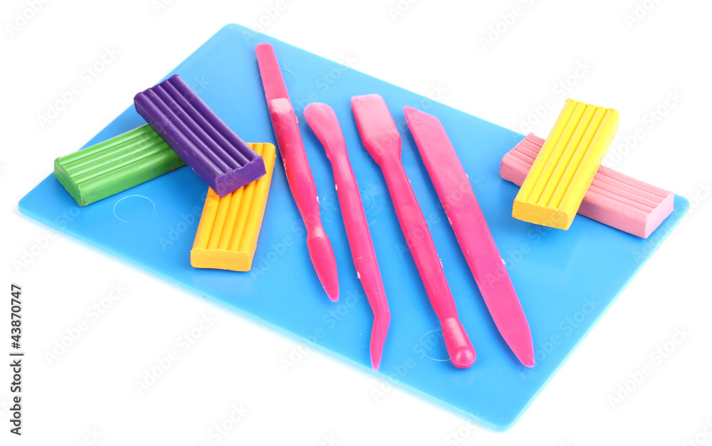 Children bright plasticine on desk with stacks isolated on