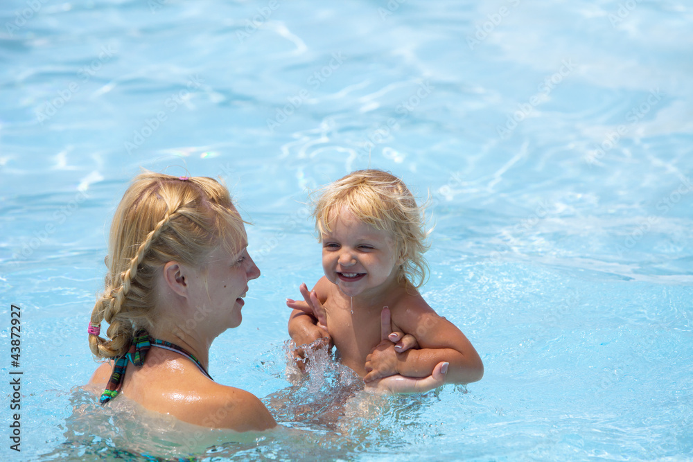 Child having fun in water with mom. Child having fun in water with mom.