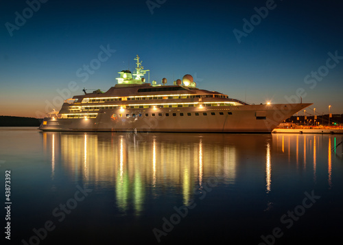 Modern cruise liner in the harbor at night