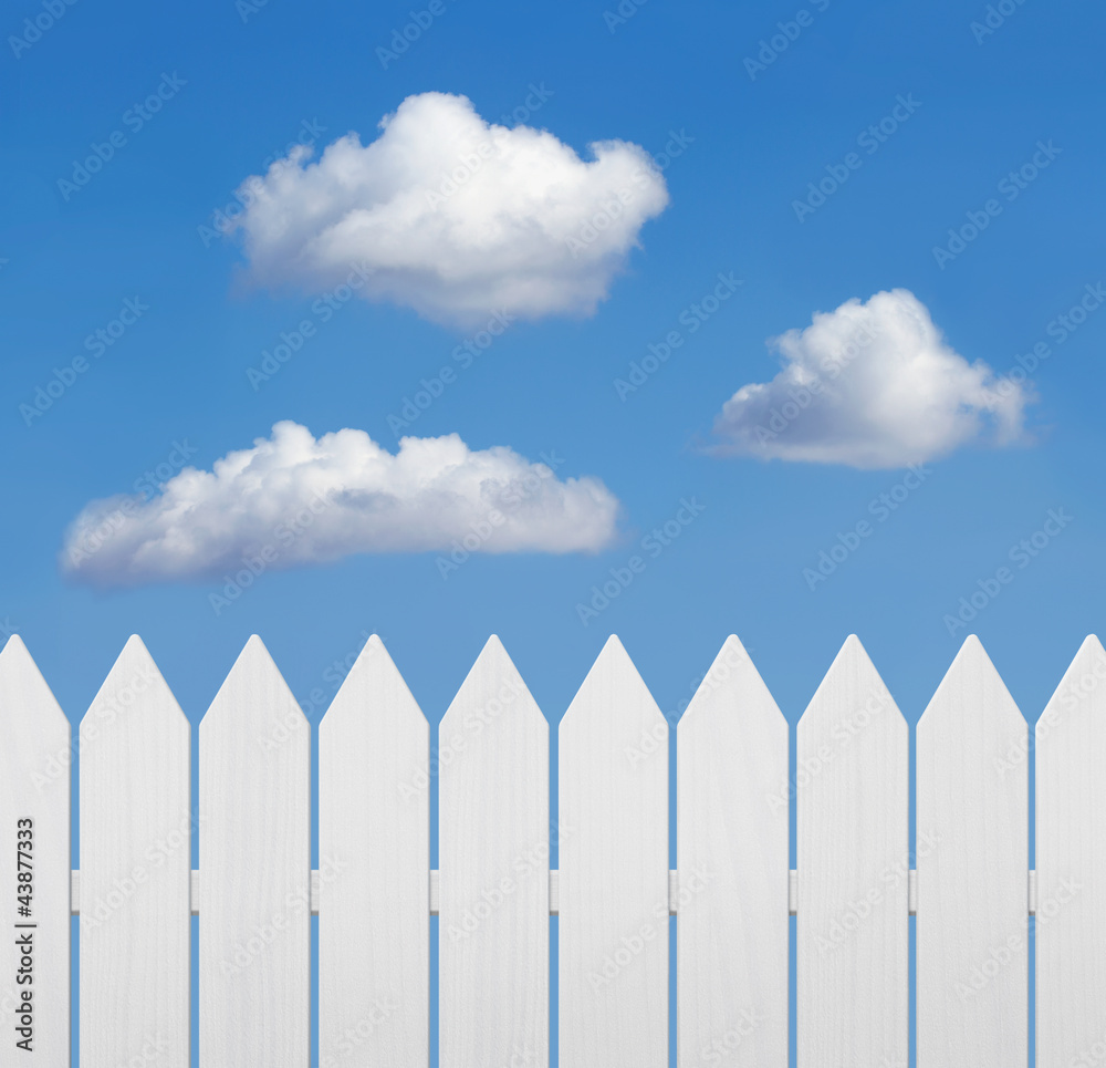 White wooden fence against blue sky