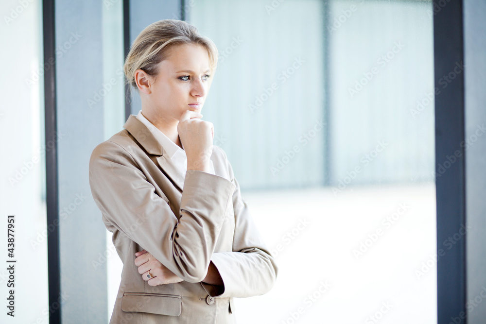 thoughtful young businesswoman looking outside of window thoughtful young businesswoman looking outside of window