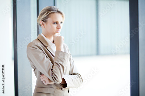 thoughtful young businesswoman looking outside of window Free Download thoughtful young businesswoman looking outside of window - GFXLoad