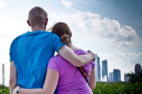 Closeup back view of young couple admiring city skyline