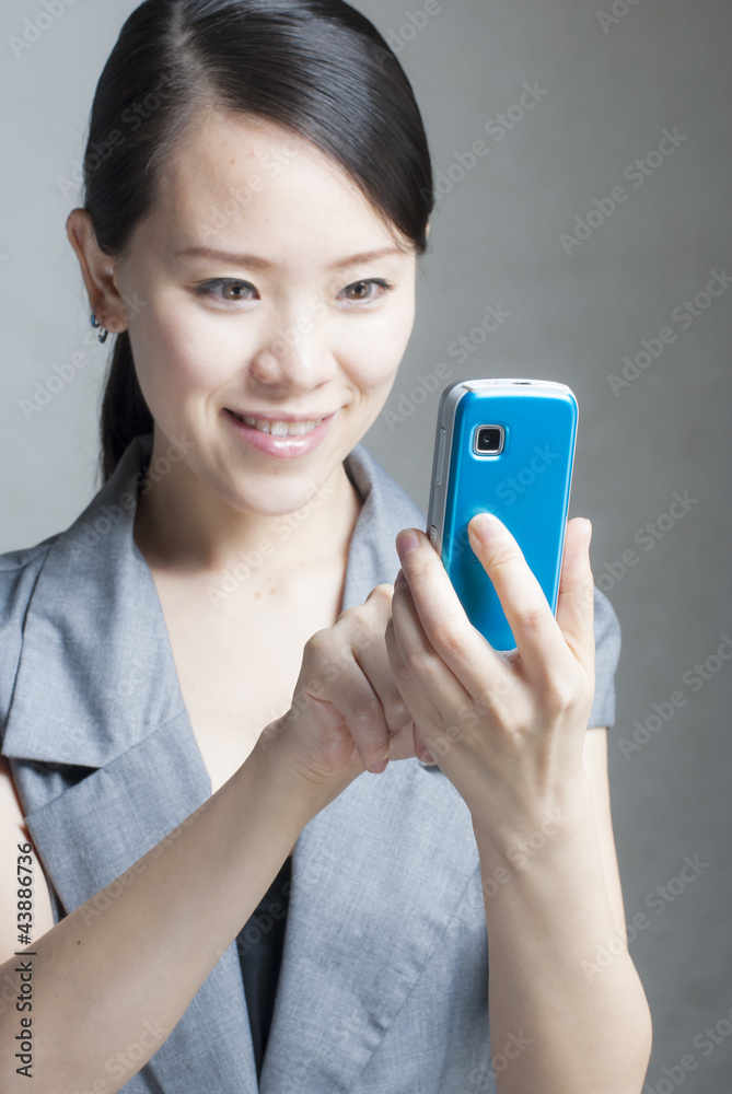 Attractive businesswoman using mobile phone Attractive businesswoman using mobile phone