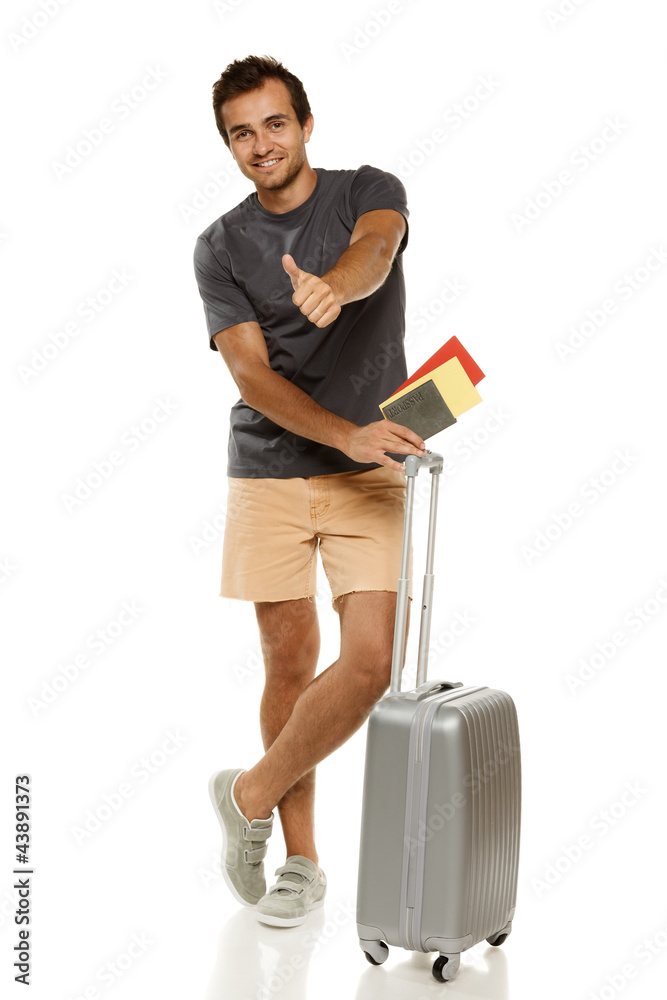 Man standing with silver suitcase, showing thumb up sign Man standing with silver suitcase, showing thumb up sign