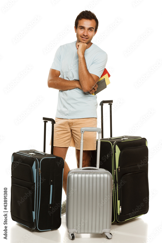Full length of man standing with three travel suitcases Full length of man standing with three travel suitcases
