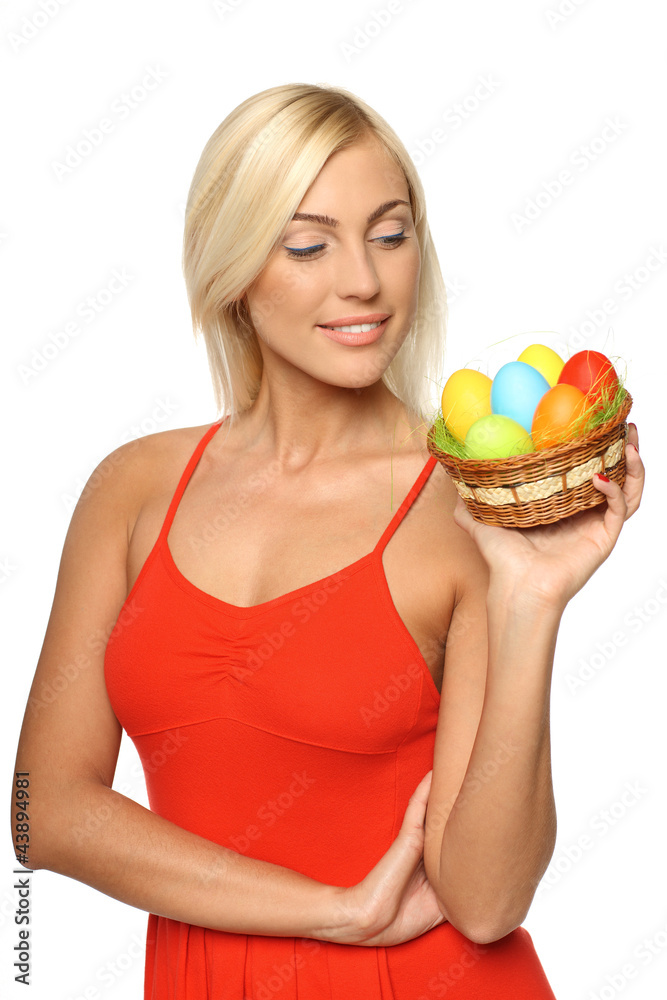 Female holding basket with Easter eggs, looking at the basket Female holding basket with Easter eggs, looking at the basket