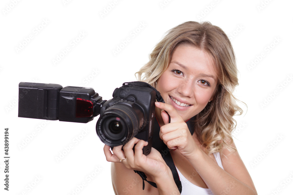 Cheerful woman shooting with a camera against white background Cheerful woman shooting with a camera against white background