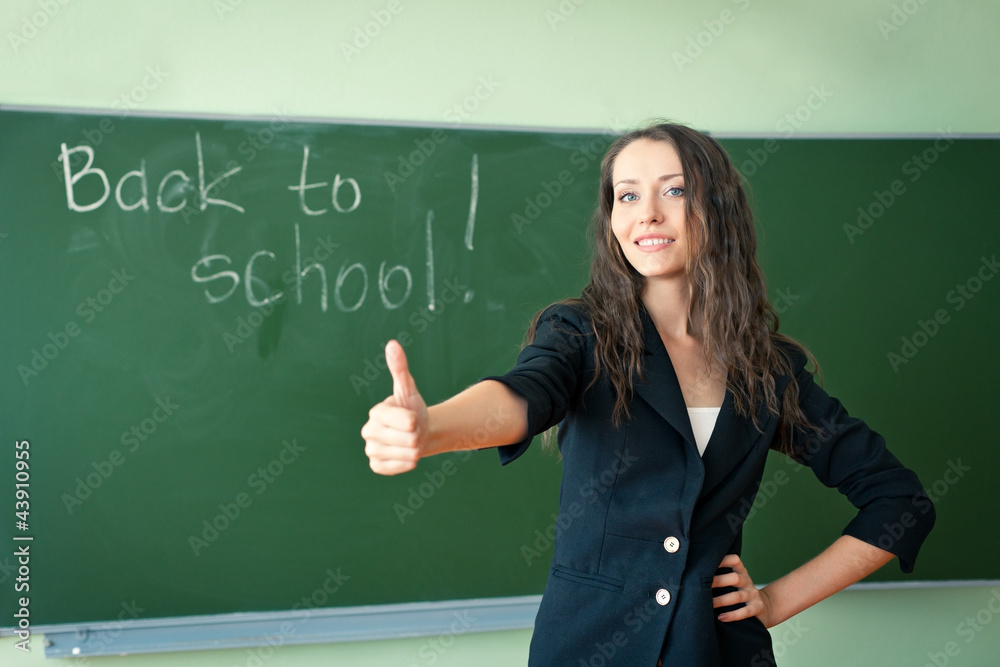 woman standing over chalkoard