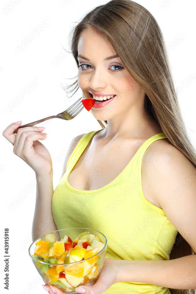 Portrait of a young woman eating fruit salad Portrait of a young woman eating fruit salad