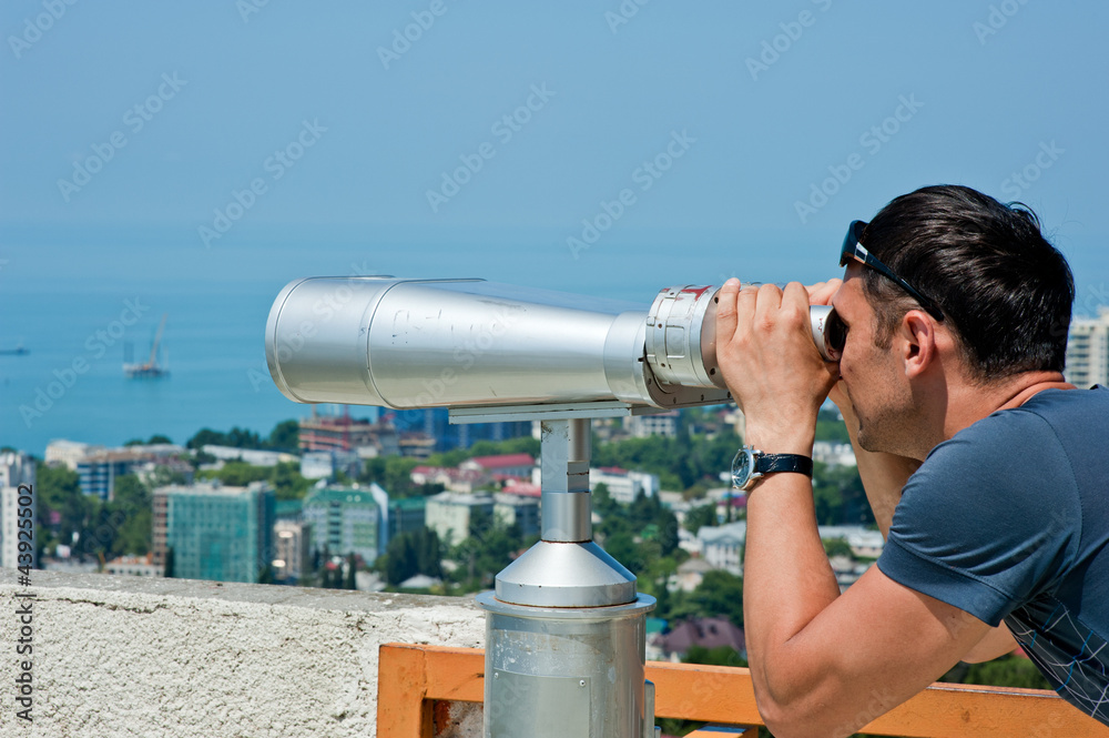 man  looking through binoculars