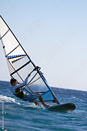 Side view of a windsurfer mooving horizontally