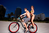 Young couple on Miami Beach Riding bikes and having fun