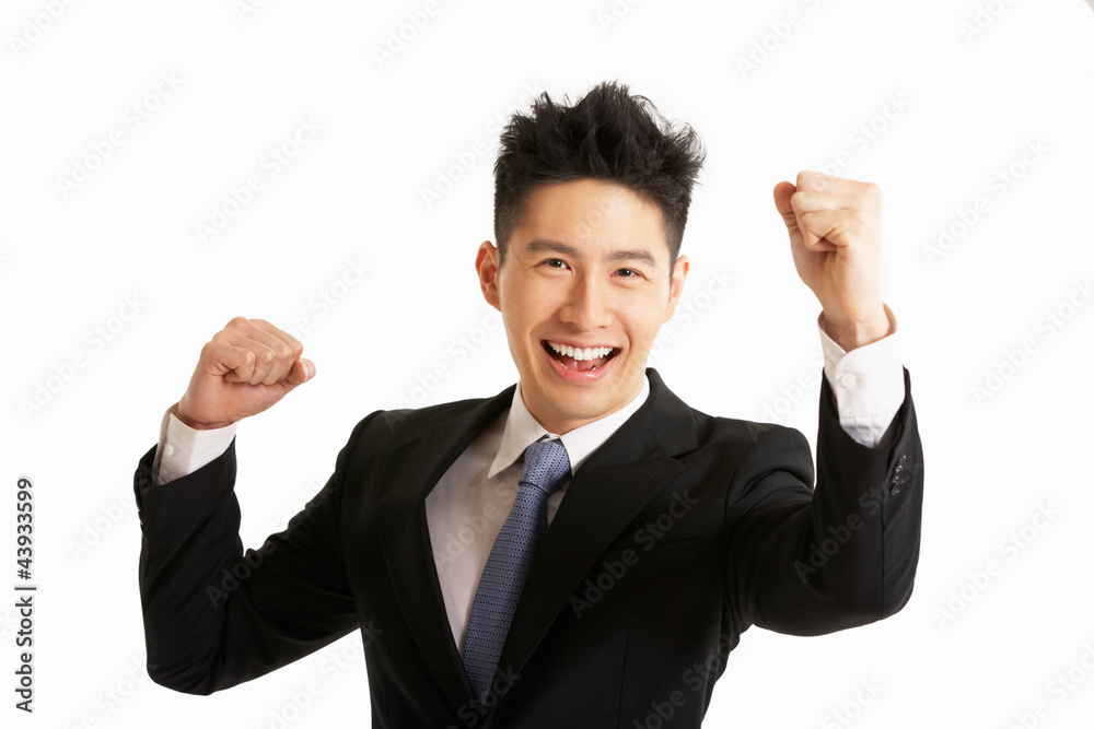 Studio Portrait Of Chinese Businessman Celebrating Studio Portrait Of Chinese Businessman Celebrating