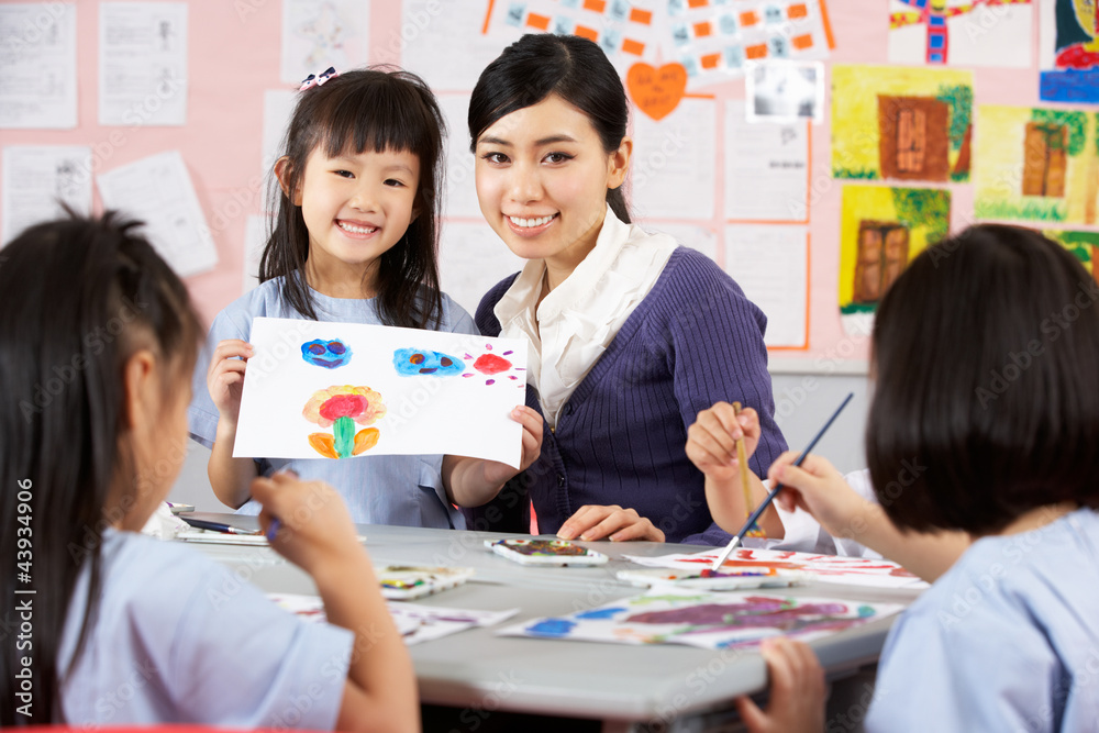 Teacher Helping Students During Art Class In Chinese School Stock Photo ...