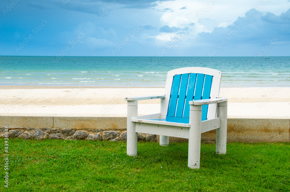 Blue armchair on Green Grass at the Beach