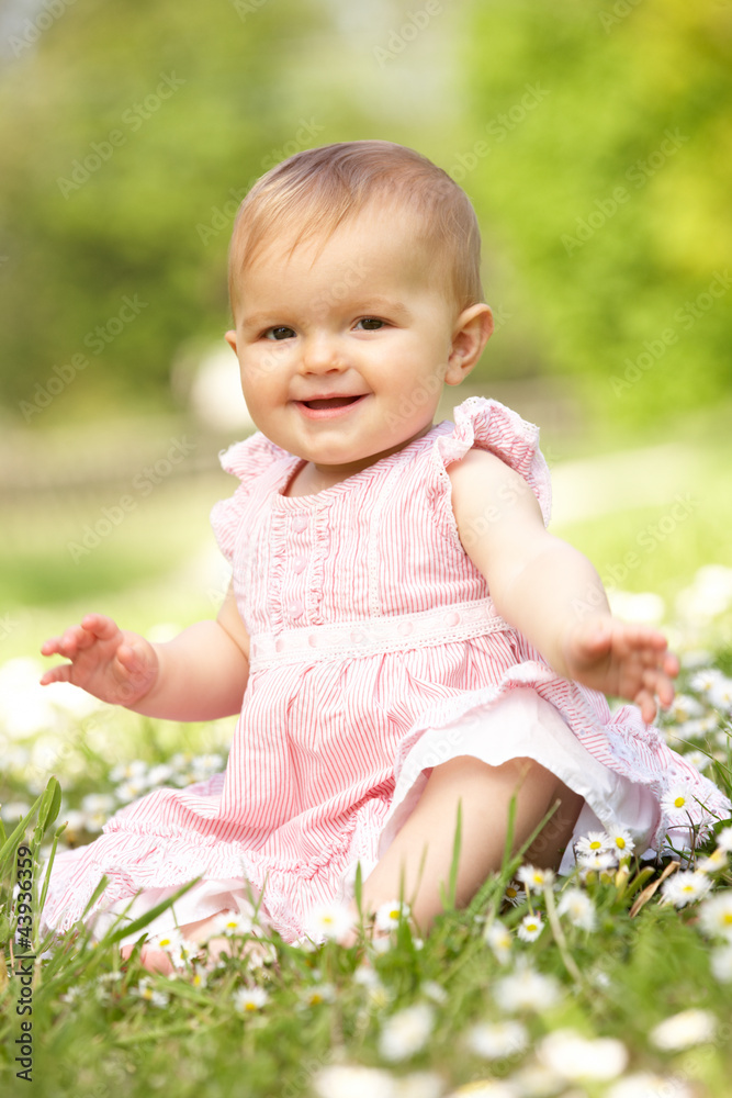 Baby Girl In Summer Dress Sitting In Field Baby Girl In Summer Dress Sitting In Field
