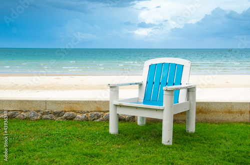 Blue armchair on Green Grass at the Beach