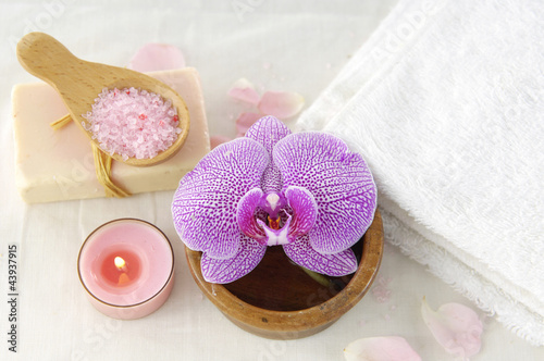 Spa products with orchid flowers and candle,