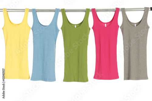 Many female shirt hanging on wooden hangers