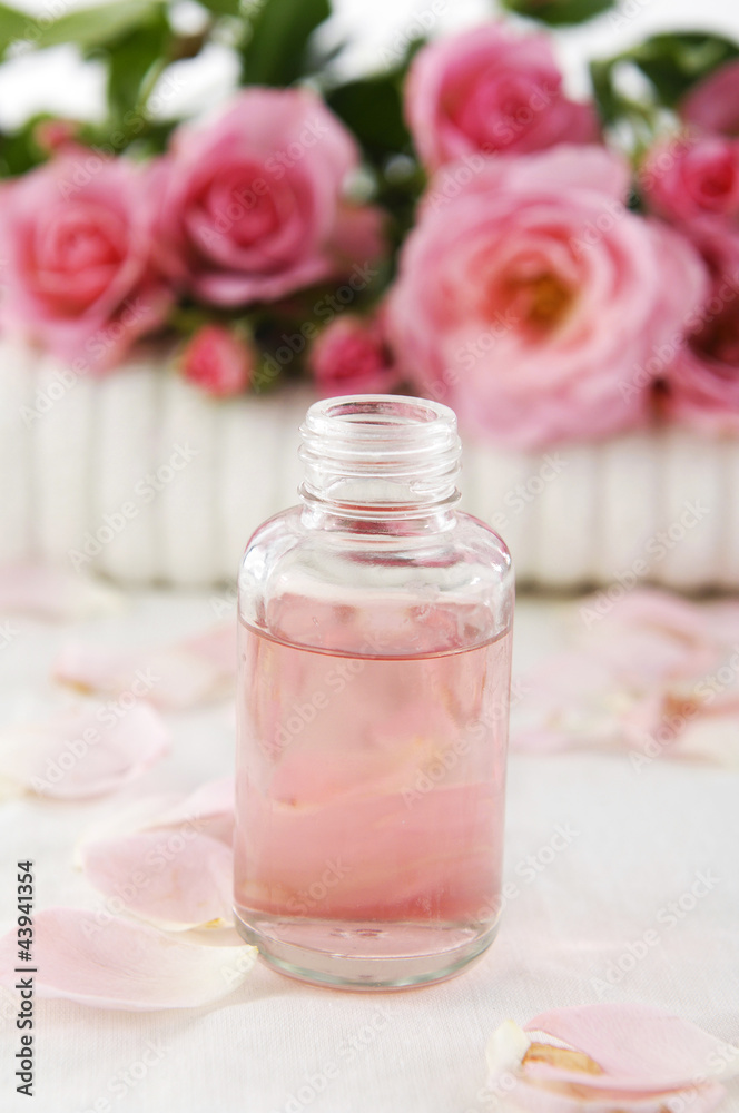branch rose on towel and massage oil on towel branch rose on towel and massage oil on towel