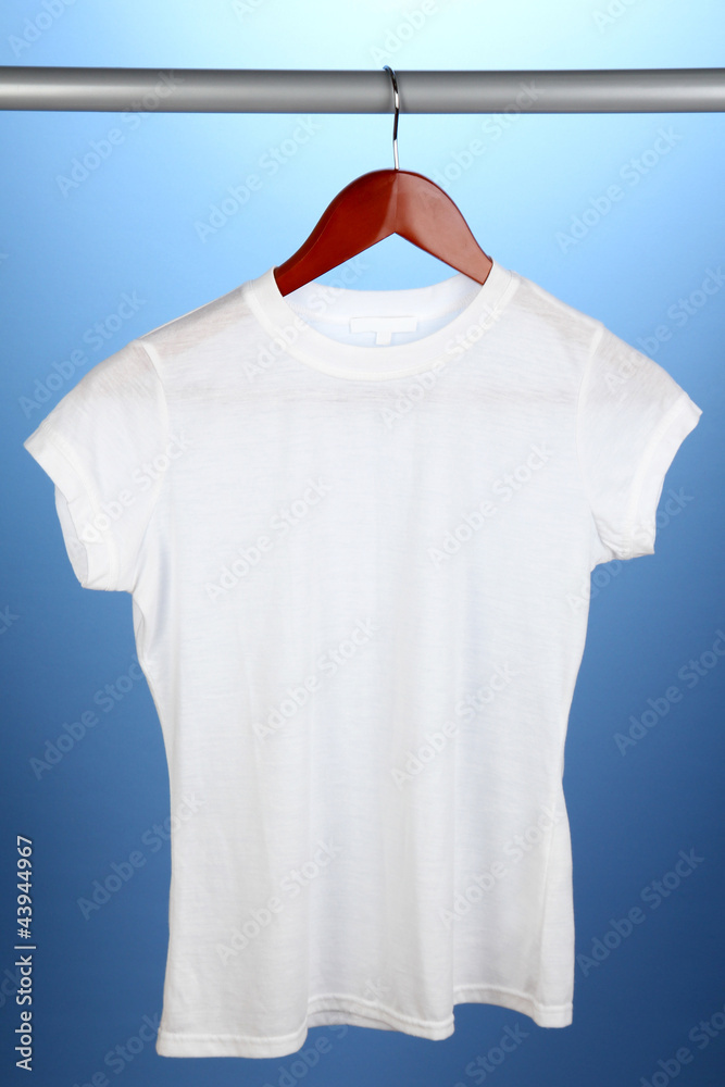 White t-shirt on hanger on blue background White t-shirt on hanger on blue background