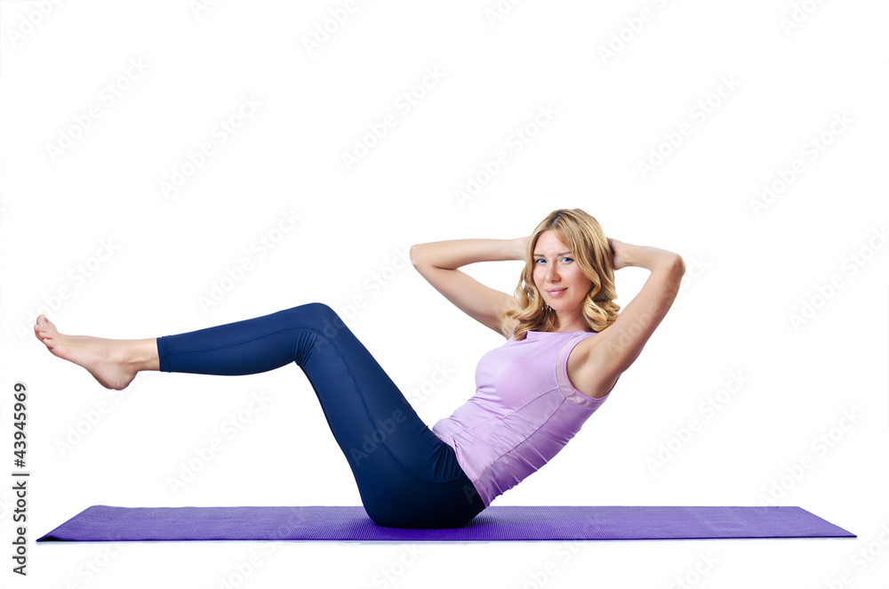 Female sportsman doing exercises on white