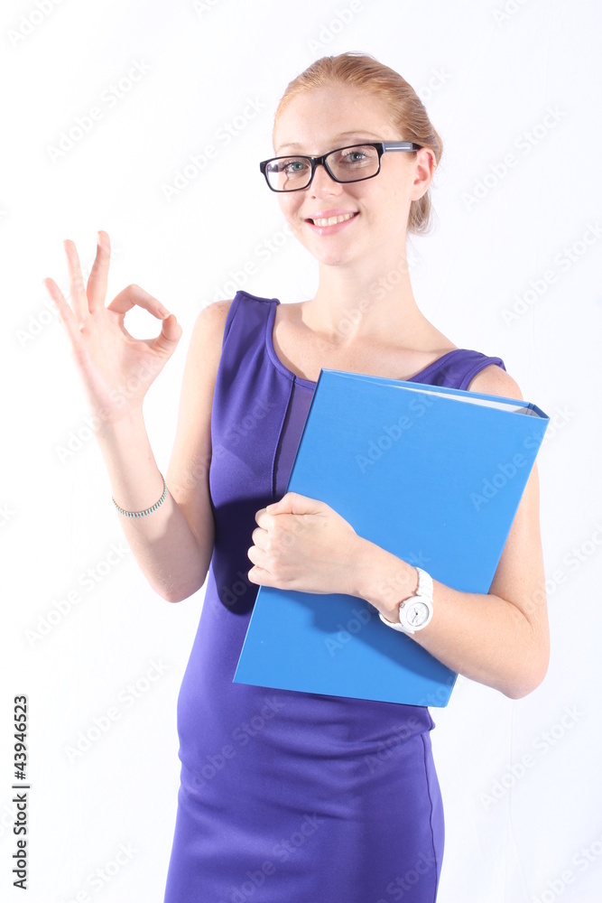 Pretty redhead woman holding a folder, doing the OK sign Pretty redhead woman holding a folder, doing the OK sign