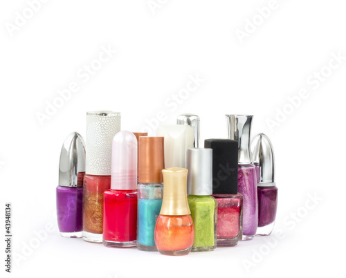 Several colorful bottles of nail polish on white background