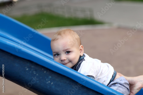 Child climbing up slide