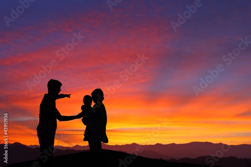 silhouette of family watching the sunrise