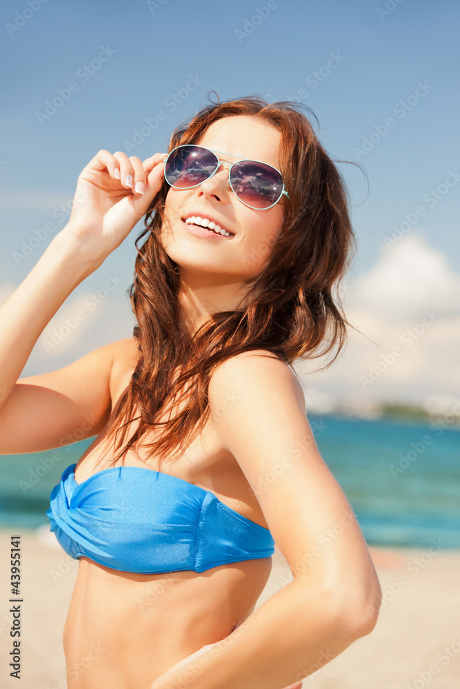 happy woman in sunglasses on the beach happy woman in sunglasses on the beach