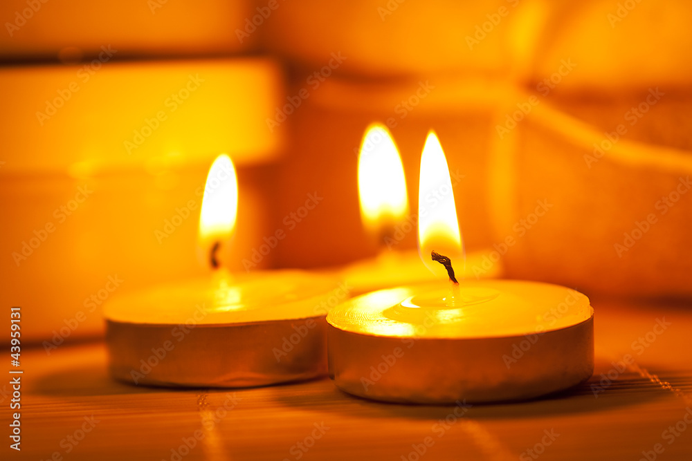 Miniature candles on a bamboo mat
