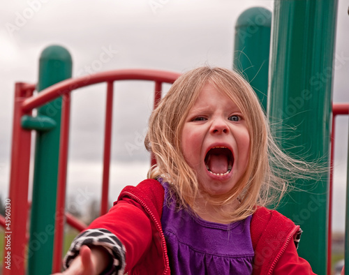 Angry Preschool Girl on Playground photo