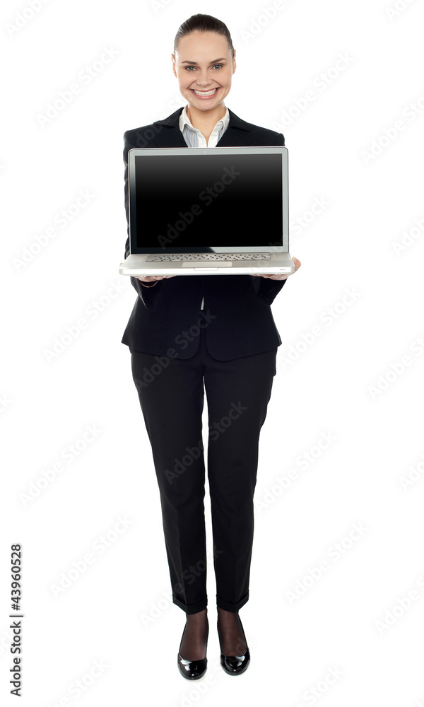 Full length portrait of woman presenting new laptop