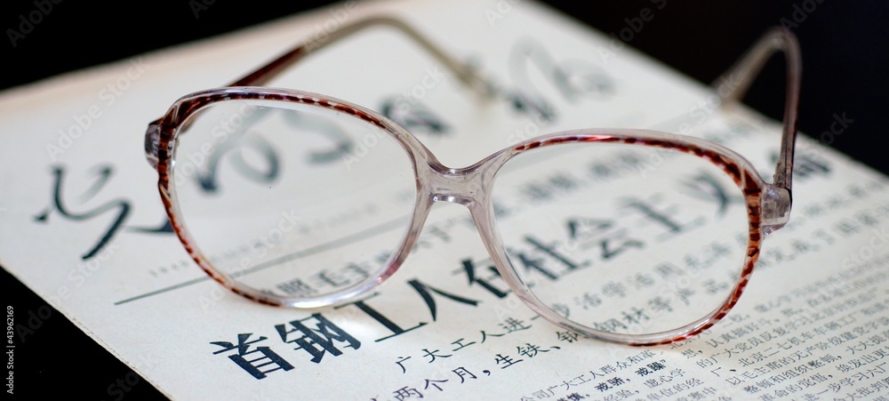 glasses on old newspaper in Chinese glasses on old newspaper in Chinese