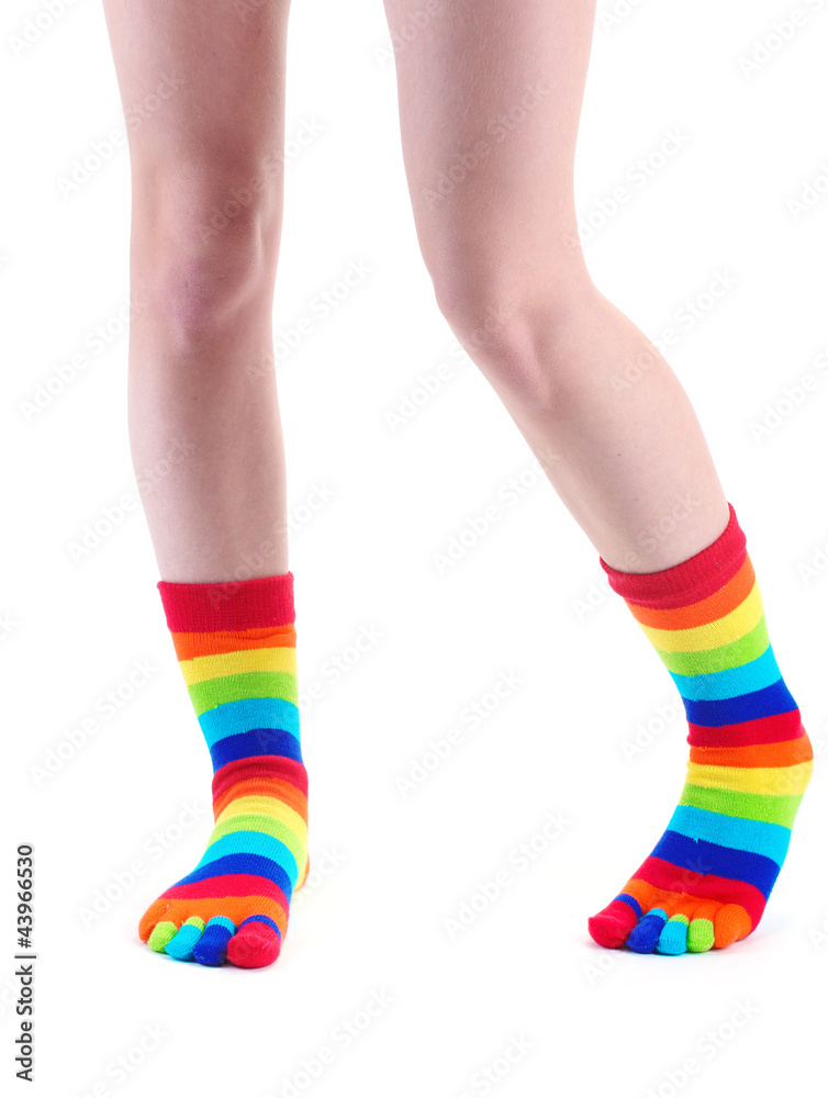 female legs in colorful striped socks isolated on white female legs in colorful striped socks isolated on white