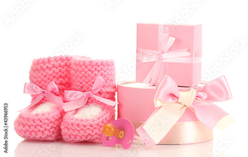 Fototapeta Naklejka Na Ścianę i Meble -  pink baby boots,  pacifier and gifts isolated on white