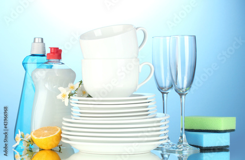 empty clean plates, glasses and cups with dishwashing liquid,