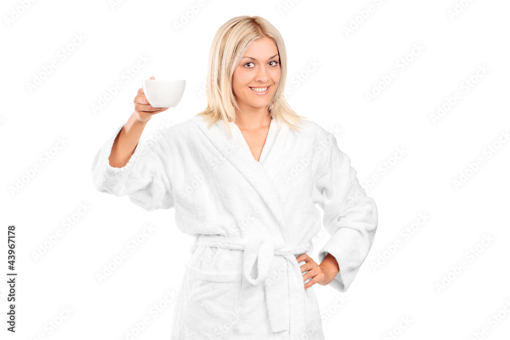 A blond woman in bathrobe holding a coffee cup A blond woman in bathrobe holding a coffee cup