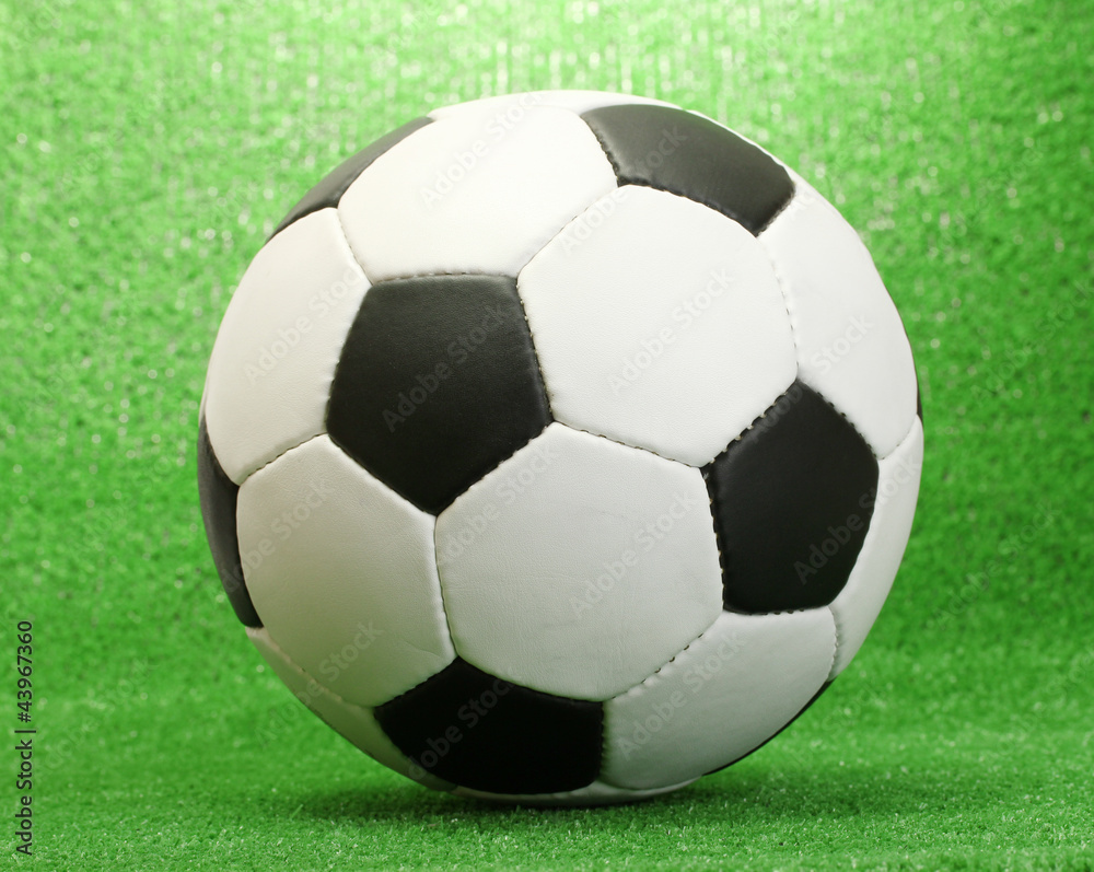 football ball on artificial green grass