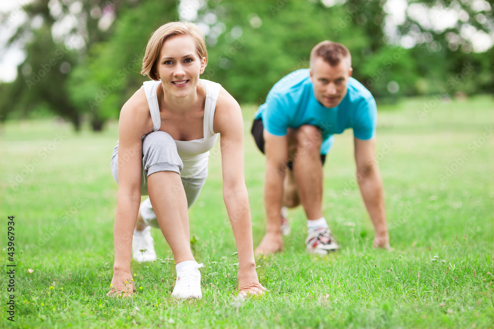 Couple working out in park