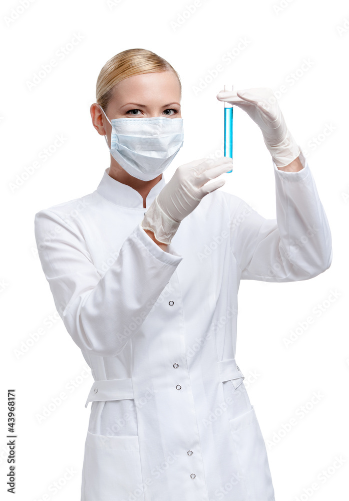Woman doctor in respirator hands vial with blue liquid Woman doctor in respirator hands vial with blue liquid