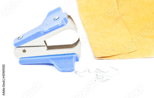 staple remover with used staples lying on the white background