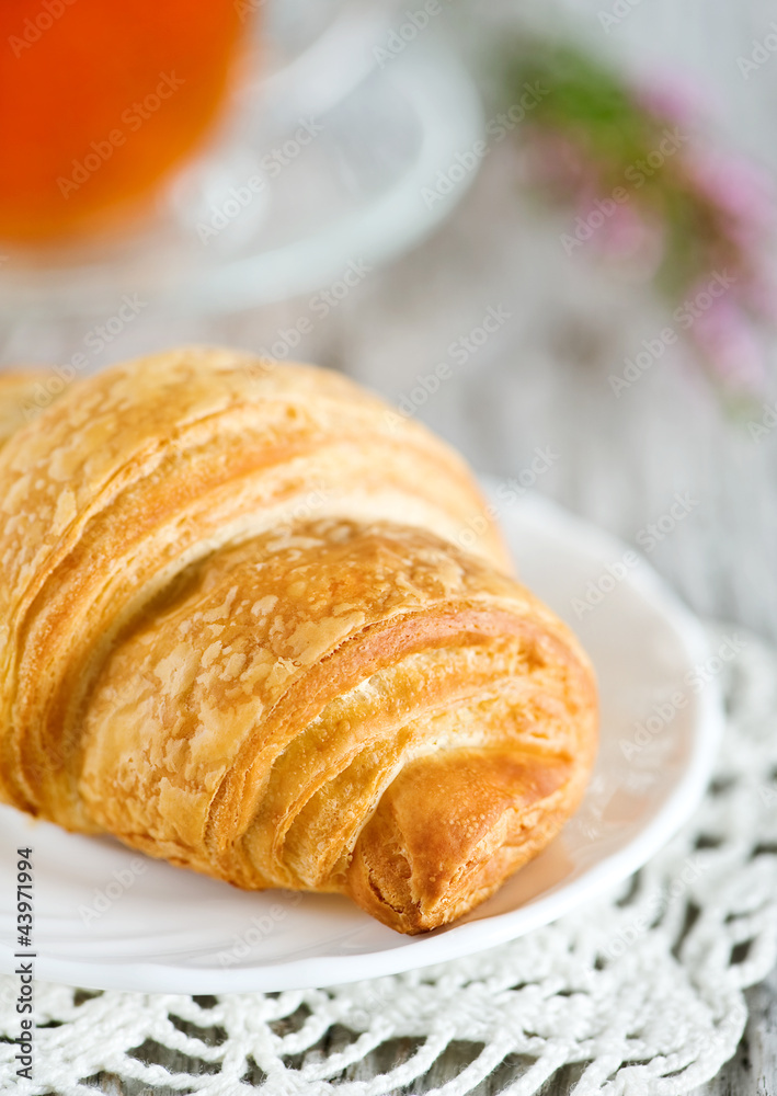 Croissant with cup of tea