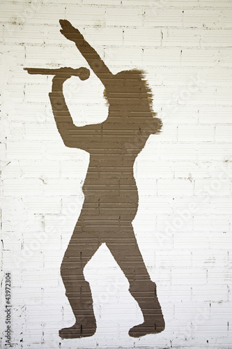 singer on brick wall