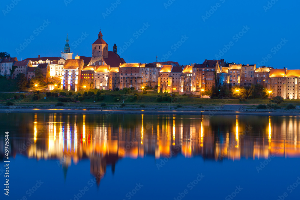 Grudziadz at night with reflection in Wisla river, Poland