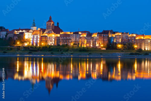 Grudziadz at night with reflection in Wisla river, Poland